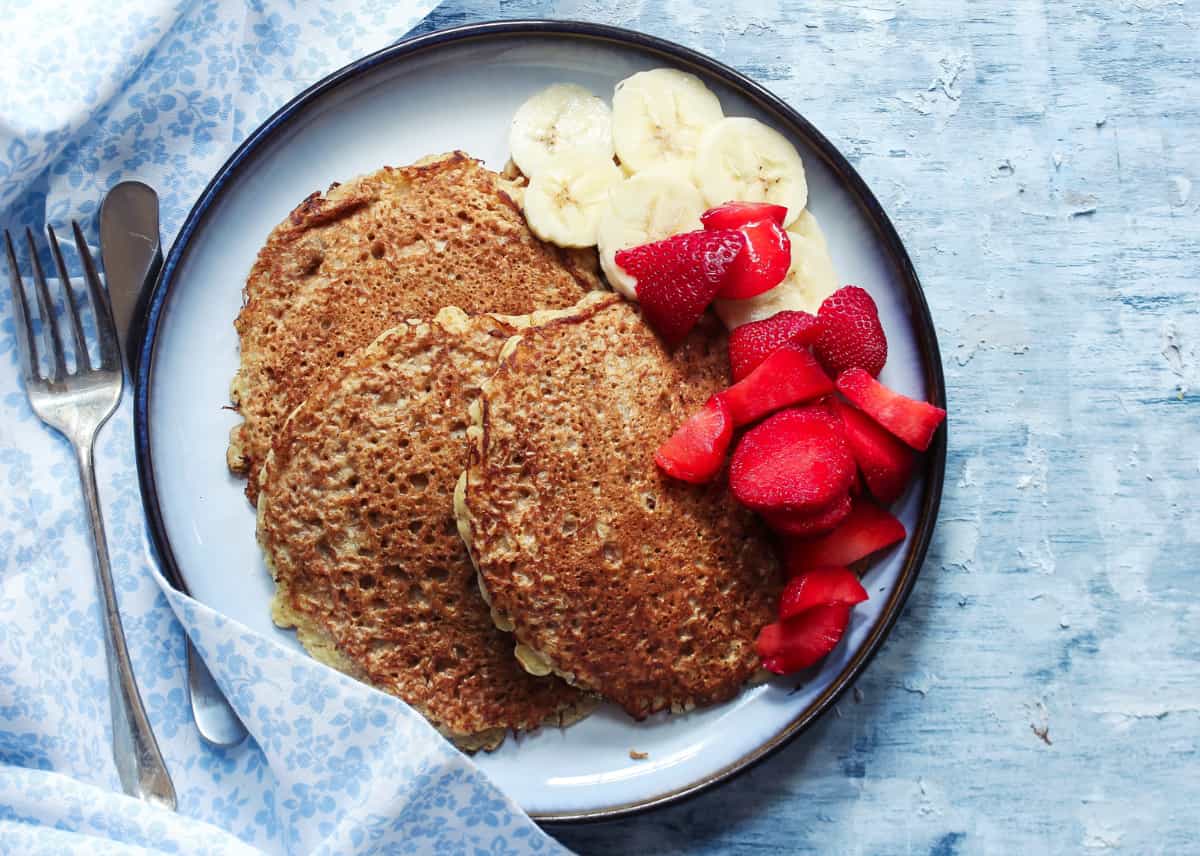 Healthy banana pancakes topped with strawberries and banana