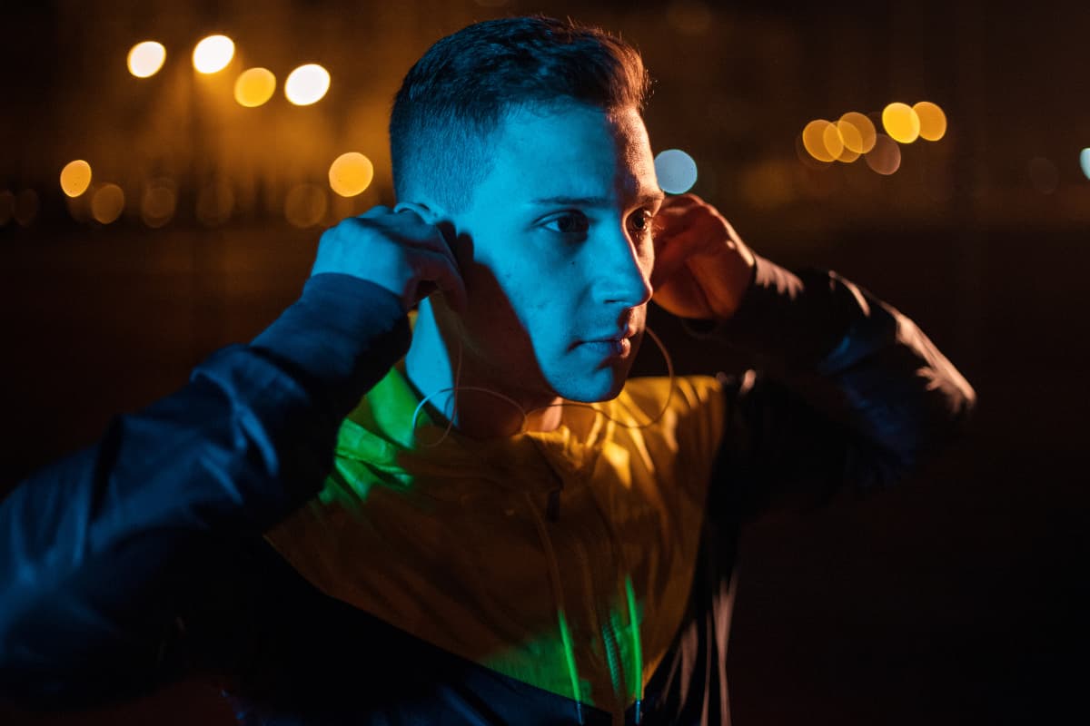 Guy listening to music during night workout