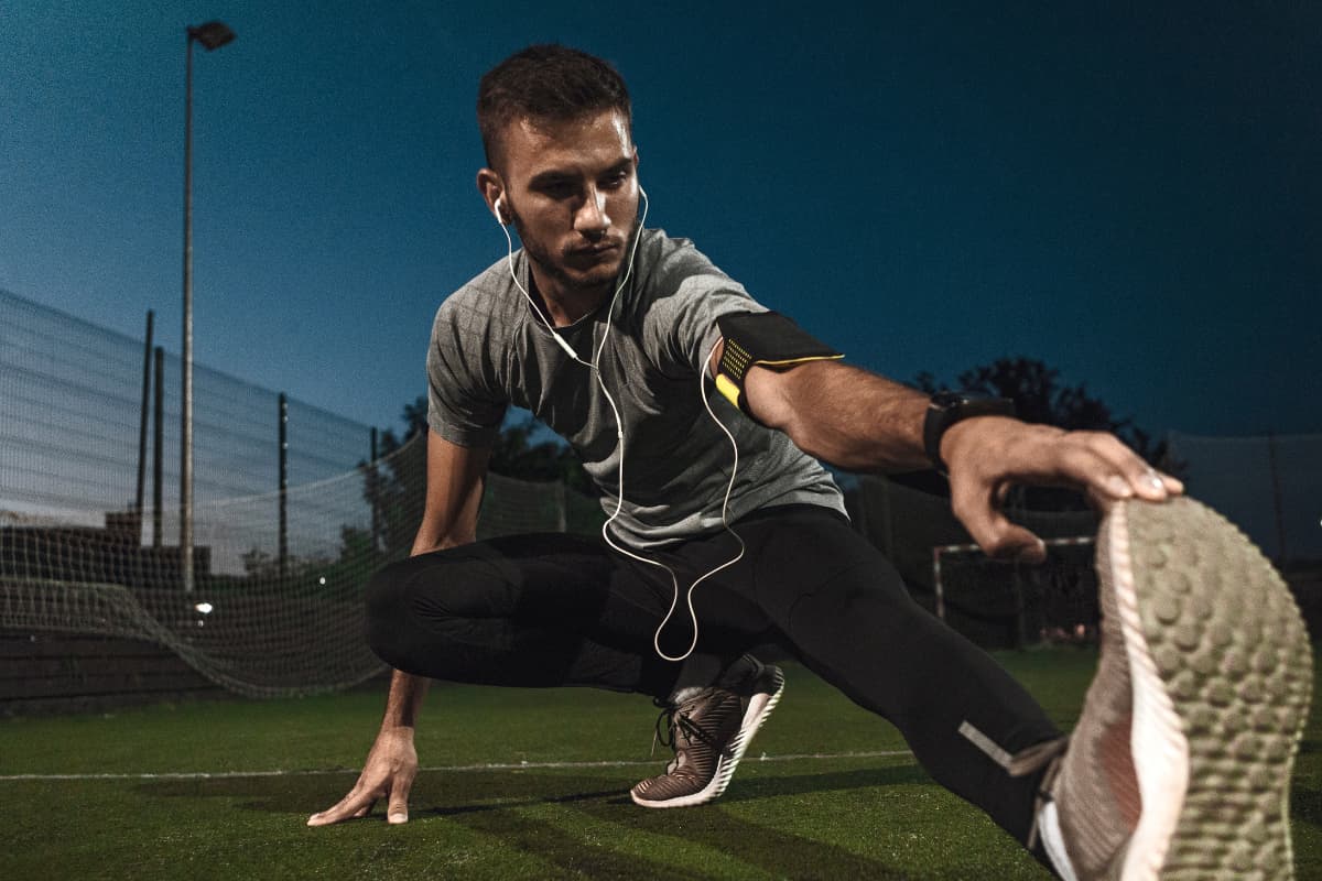 Man stretching before a night workout